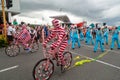 Cyclists in candy-striped body suits at Christmas parade