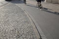 Cyclists on Cobblestone Street; Christianshavn; Copenhagen Royalty Free Stock Photo