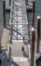 Cyclists cross a mobile ramp on a floating dock on a river