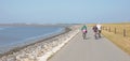 Cyclists cycling on a dyke