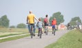 Cyclists cycling on a dyke