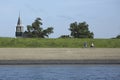 Cyclists on the dike at Oudeschild, Texel, The Netherlands