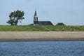 Cyclists on the dike at Oudeschild, Texel, The Netherlands