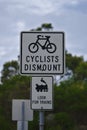 Cyclists dismount Look for trains sign Royalty Free Stock Photo