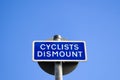 Cyclists dismount sign