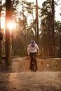 Cyclists in the forest on a track with slides for sport mountain Biking. Mountain bike jumping, extr