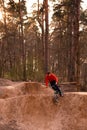 Cyclists in the forest on a track with slides for sport mountain Biking. Mountain bike jumping, extr