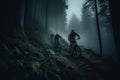 cyclists going down a mountain slope in the forest Royalty Free Stock Photo
