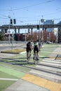 Cyclists man and woman practice cycling and ride a bike path along a road along a modern city street