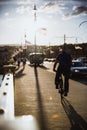 Cyclists on Margaret Bridge, Margit hid, above Danube river in Budapest, Hungary on sunset. The bridge connects Buda, Pest and Royalty Free Stock Photo