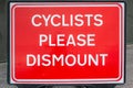 Cyclists please dismount sign
