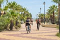 Cyclists on the promenade, Costa de Luz, Ayamonte, Spain.