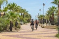 Cyclists on the promenade, Costa de Luz, Ayamonte, Spain.