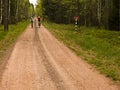 Cyclists on red dirt path in forest Royalty Free Stock Photo