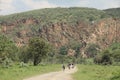 People ride bikes through the Hell's Gate National Park in Kenya Royalty Free Stock Photo