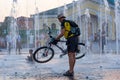 Cyclists riding along the waterfront. Sunset between houses of old architecture in Kyiv. Editorial. 08.03.2017