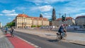 Cyclists at road and Herbstmarkt and Holy Cross Church bell and clock tower. Panoramic cityscape of beautiful modern Dresden. Royalty Free Stock Photo