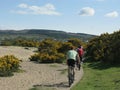 Cyclists on a sandy beach on the Isle of Arran, Scotland