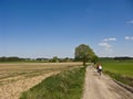 Cyclists in spring or summer dirt path Royalty Free Stock Photo