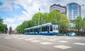 Cyclists and train cross intersection in city together