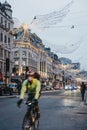 Cyclists under angel Christmas lights on Regent Street, London, UK, motion blur Royalty Free Stock Photo