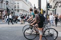 Cyclists waiting for traffic lights on Oxford Street, London, UK.