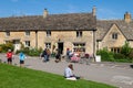 Cyclists and walkers outside the Old Post Office on the green in the Cotswolds Royalty Free Stock Photo