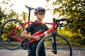 Cyclo-cross competition member Man biker carrying bike up on going on road