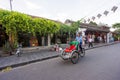 Cyclo driver is riding tourist on the street of Hoi An, Vietnam