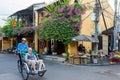 Cyclo driver is riding tourist on the street of Hoi An, Vietnam