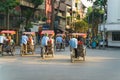 Cyclo driver taking tourist visiting old quarter on street in Hanoi