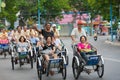 Cyclo drivers carry tourists