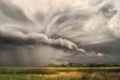 Cyclone storm over fields and meadows approaches the hilly valley. Rainy cloudy day