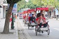 Cyclos carry tourists on street at Old Town in Hanoi, Vietnam