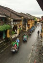 Cyclos carrying tourists on street in Hoi An, Vietnam