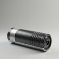 A cylindrical black and silver device, resembling a portable speaker or flashlight, with Royalty Free Stock Photo