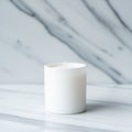 Cylindrical candle placed on a smooth, white marble surface with subtle grey Royalty Free Stock Photo