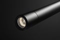 Cylindrical led spotlight emitting bright light against a dark backdrop, showcasing modern lighting design Royalty Free Stock Photo