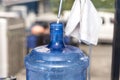 A cylindrical 20 liter HPDE water container being refilled with purified H2O. A purified water refilling station business Royalty Free Stock Photo