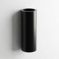 Cylindrical object mounted on a white wall. The object appears to be Royalty Free Stock Photo
