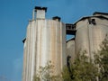 Cylindrical silos high in the sky behind the sky