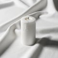 Side and the wick is unlit. The smooth matte texture of the candle contrasts Royalty Free Stock Photo