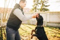 Cynologist works with service dog outside Royalty Free Stock Photo