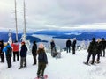 A group of snowshoers admiring the beautiful ocean views of Howe Sound from the Bowen Island Lookout on Cypress Mountain