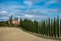 Cypress Trees rows on road to rural house, landscape in orcia near Siena, Tuscany Royalty Free Stock Photo