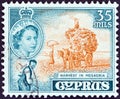 CYPRUS - CIRCA 1955: A stamp printed in Cyprus shows harvest in Mesaoria and Queen Elizabeth II, circa 1955.