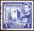CYPRUS - CIRCA 1938: A stamp printed in Cyprus shows Kolossi Castle and King George VI, circa 1938.