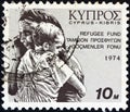 CYPRUS - CIRCA 1974: A stamp printed in Cyprus shows Turkish invasion mother and child refugees, circa 1974.