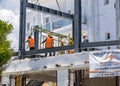 CYPRUS, Kyrenia - JUNE 10, 2019: Builders are building a new building on the roof. Workers dressed in orange vests and yellow