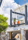 CYPRUS, Kyrenia - JUNE 10, 2019: Builders are building a new building on the roof. Workers dressed in orange vests and yellow